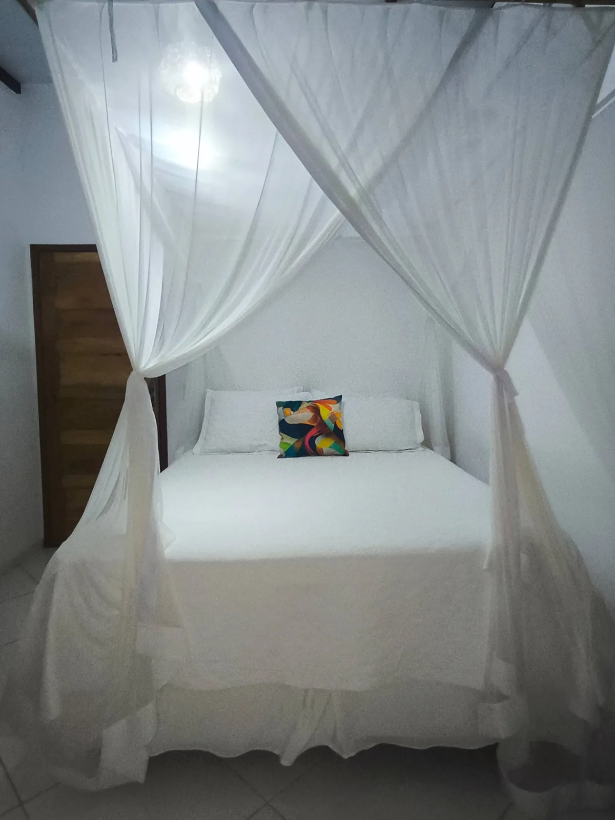Suíte com cama de casal e dossel no aluguel de temporada em Trancoso, Bahia